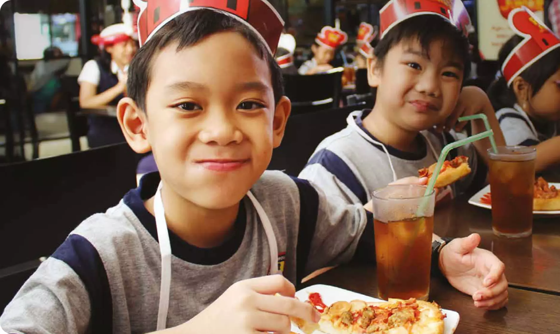 Smiling children as they are happy enjoying Pizza Hut